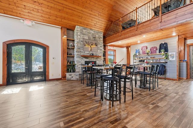 Entry doors, stone fireplace and retail wall from the hall