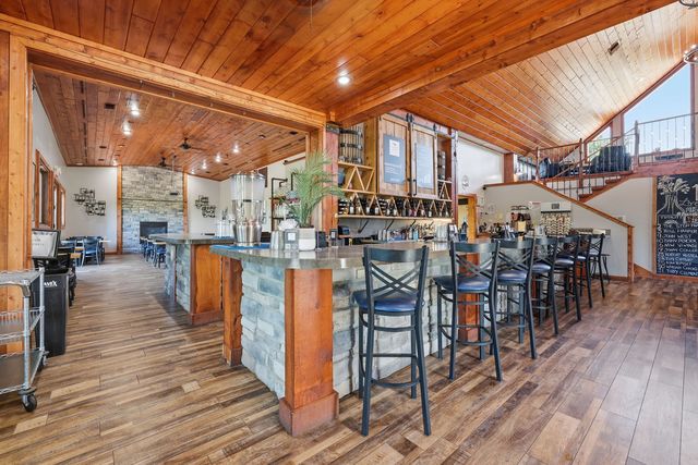 Bar peninsula with the adjoining dining room and its fireplace beyond