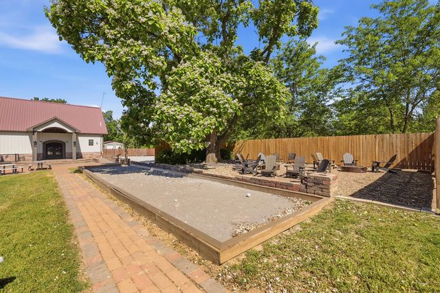 Bocce court and fire-pit courtyard beside the entry