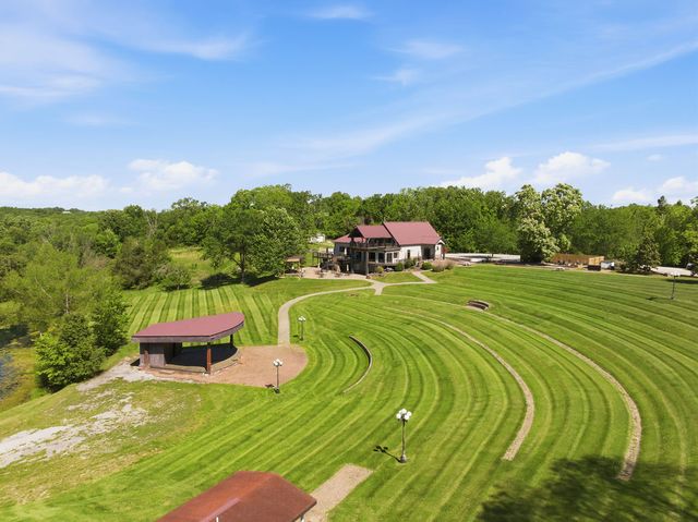 Terraced lawn amphitheater and covered stage, lodge beyond