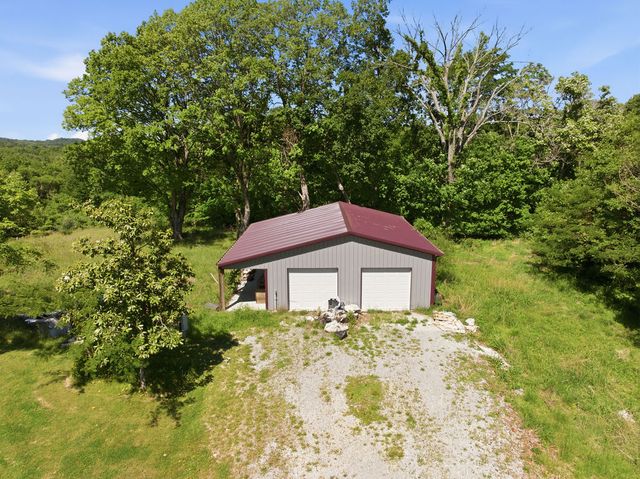 Pole-frame outbuilding with two overhead doors