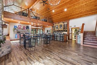 Great hall from the fireplace end: pine cathedral ceiling, loft rail, service bar and stair