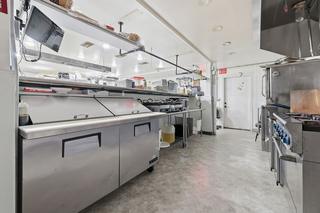 Refrigerated prep line opposite the range