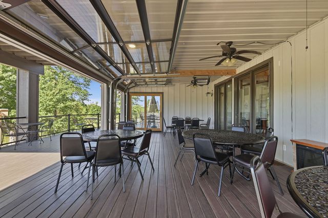 Enclosed porch with the overhead glass doors raised