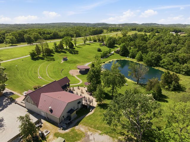 Lodge, amphitheater, stage and pond toward the ridge