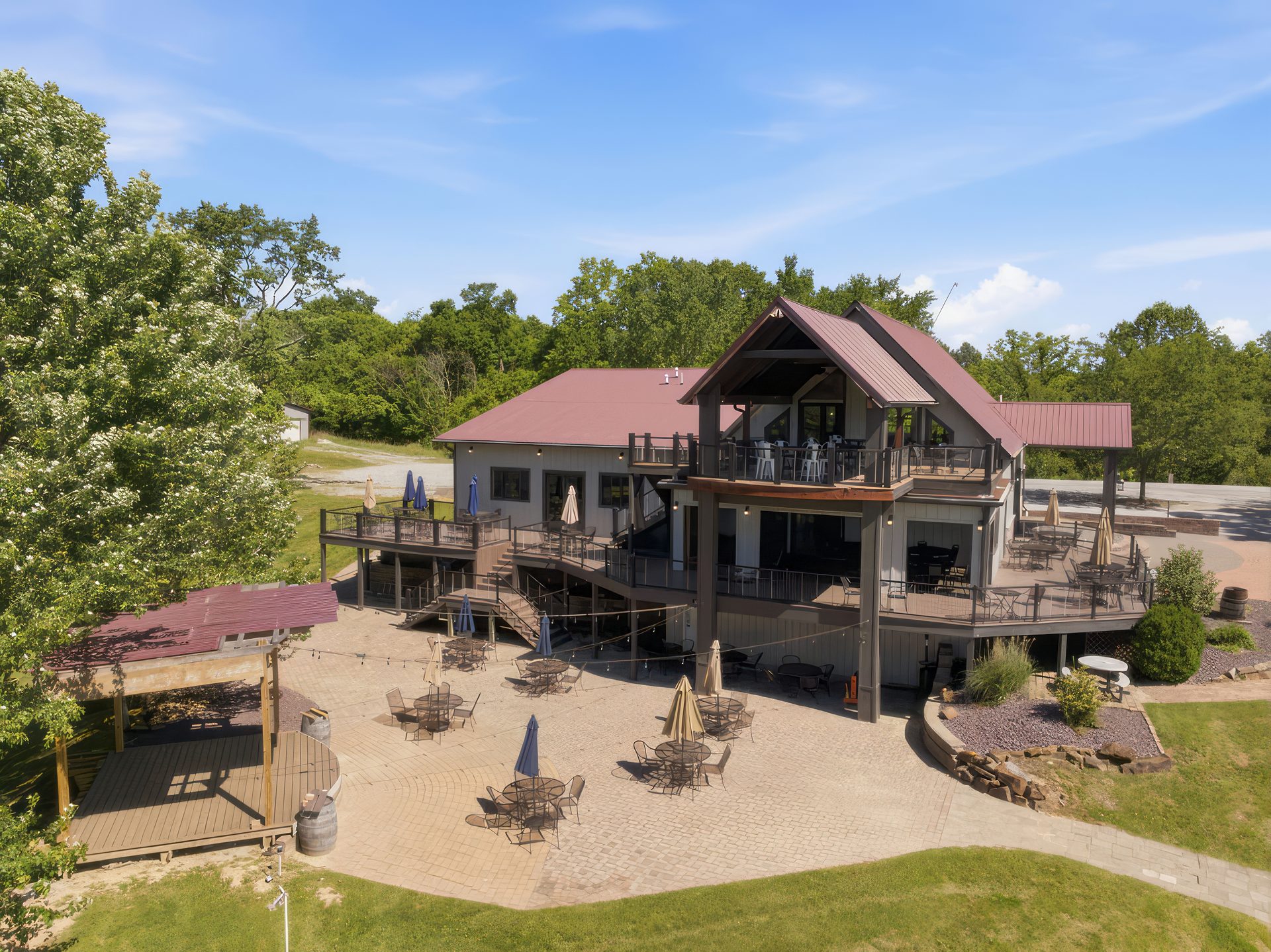 Main lodge, stacked decks and patio, centered in view