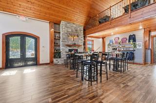 Entry doors, stone fireplace and retail wall from the hall