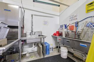 Dish room: commercial dishwasher and three-compartment sink