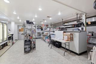 Commercial kitchen: prep tables, hood line and office desk
