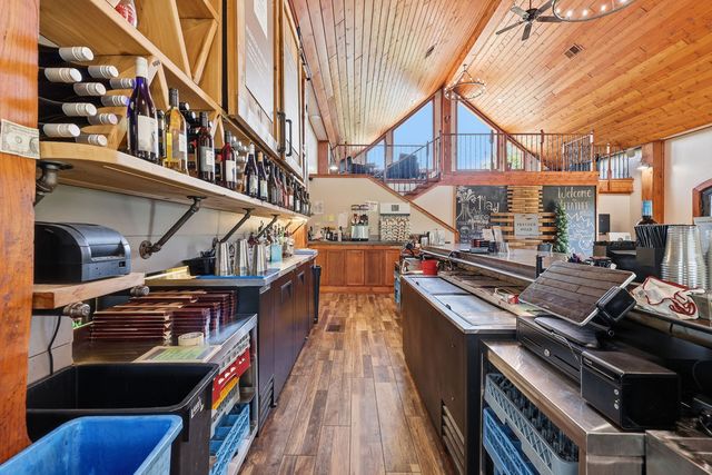 Behind the bar toward the loft stair