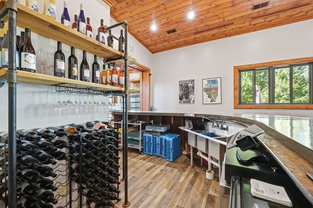Second service bar: wine racks, three-compartment sink