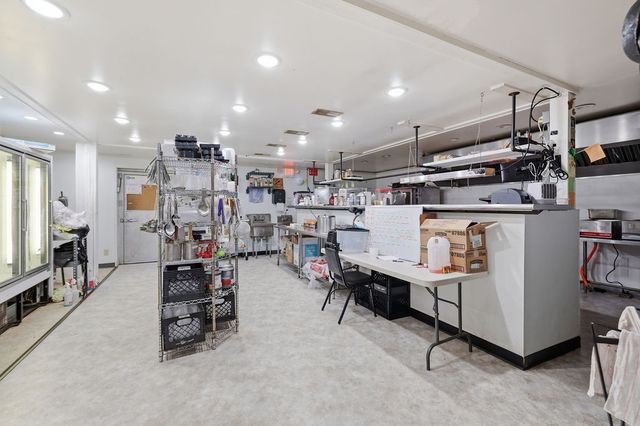 Commercial kitchen: prep tables, hood line and office desk