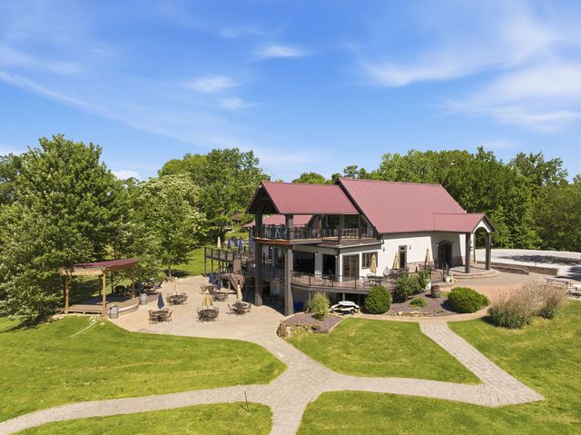 Lodge, patio and pergola from above the lawn